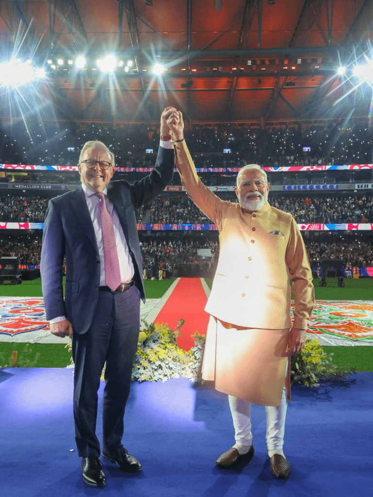 PM Narendra Modi and Australian PM Anthony Albanese celebrating the India-Australia Strategic Partnership during a public event in Australia.